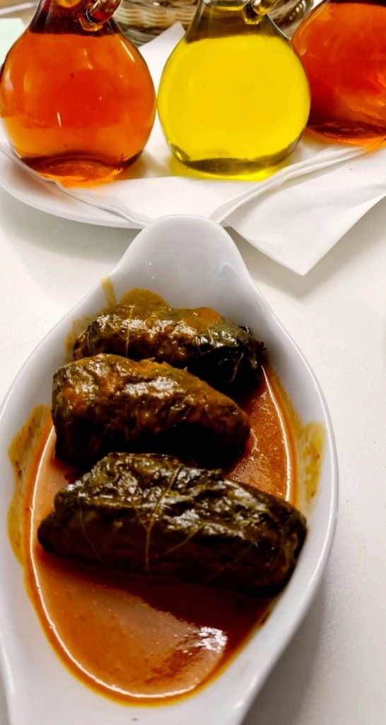 Stuffed vine leaves (dolmades) in a savoury red sauce