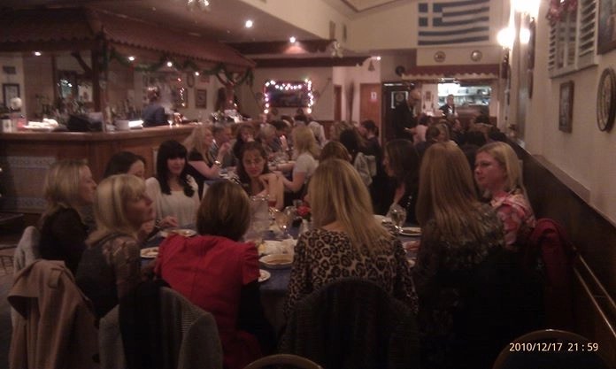 A large group sharing a long table in the taverna