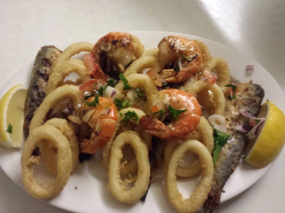Mixed seafood platter of calamari, king prawns and grilled fish